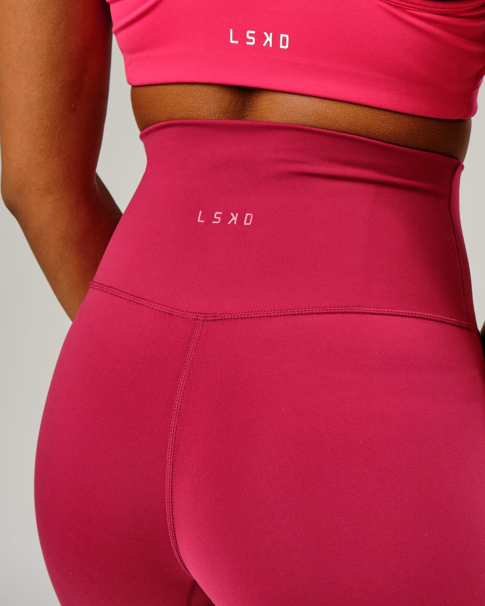 Model wearing Base Mid Short Tight - Candy Apple