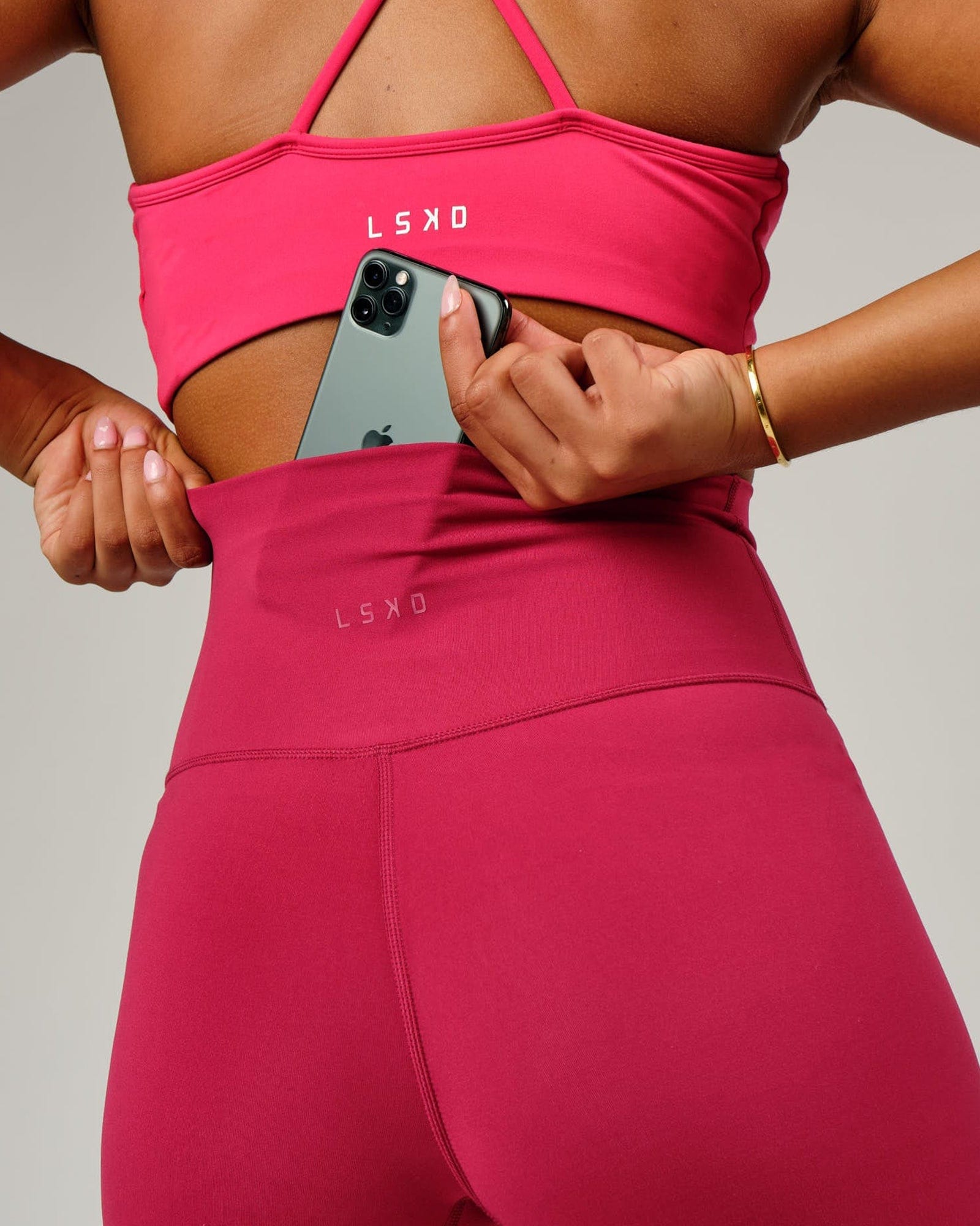 Model wearing Base Mid Short Tight - Candy Apple