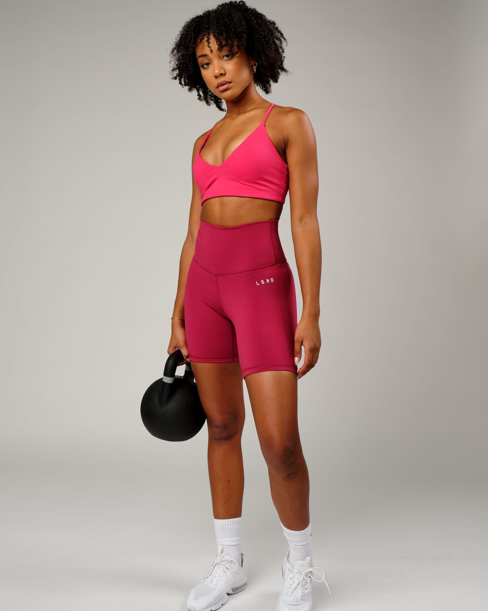 Model wearing Base Mid Short Tight - Candy Apple