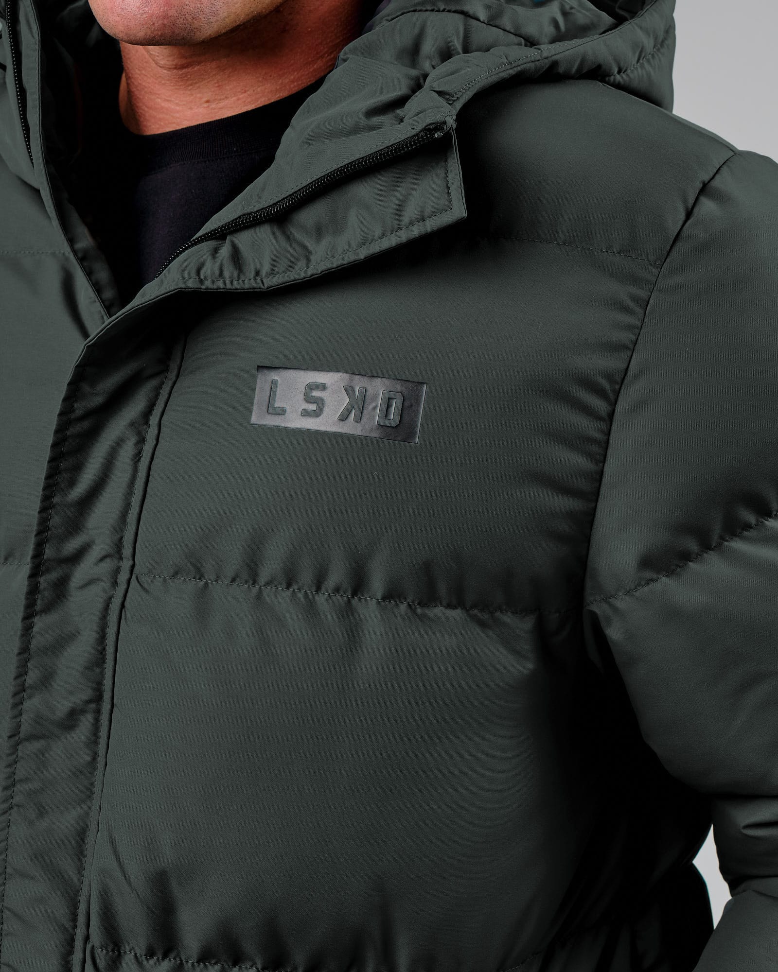 Model wearing Unisex Roasted Puffer Jacket Oversize 22 - Carbon Green