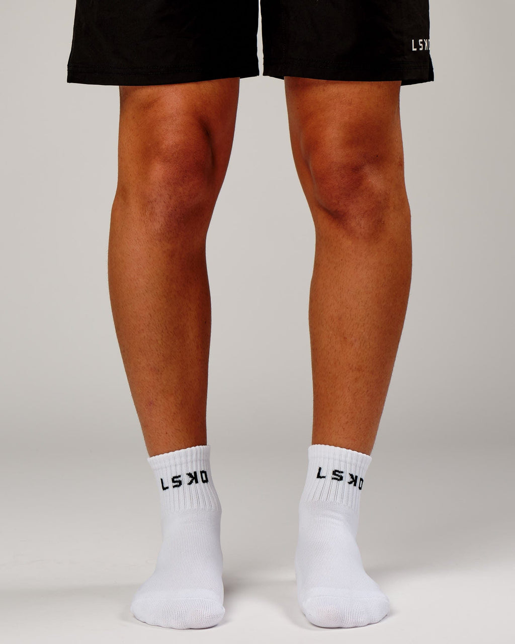 Model wearing Base Quarter Sock - White