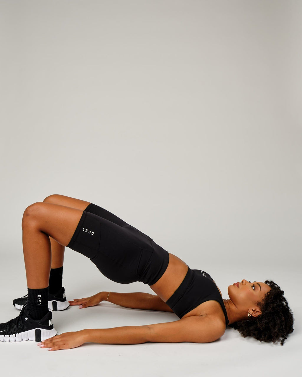 Model wearing Rep Short Tight Small Logo - Black