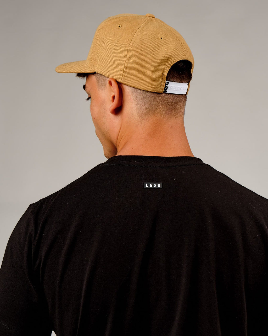 Model wearing Cornerstone Cap - Camel