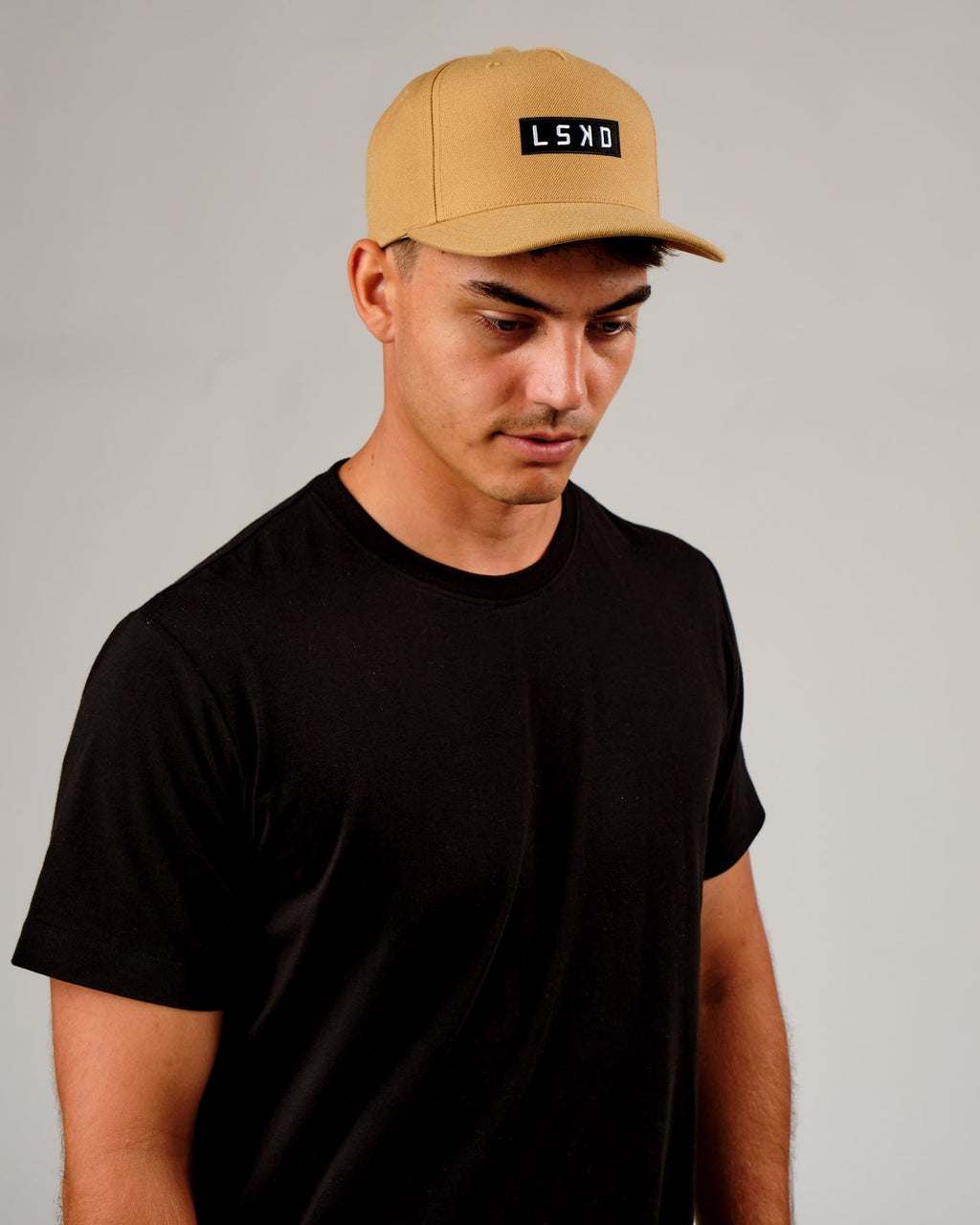 Model wearing Cornerstone Cap - Camel
