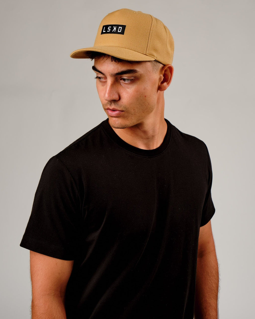 Model wearing Cornerstone Cap - Camel