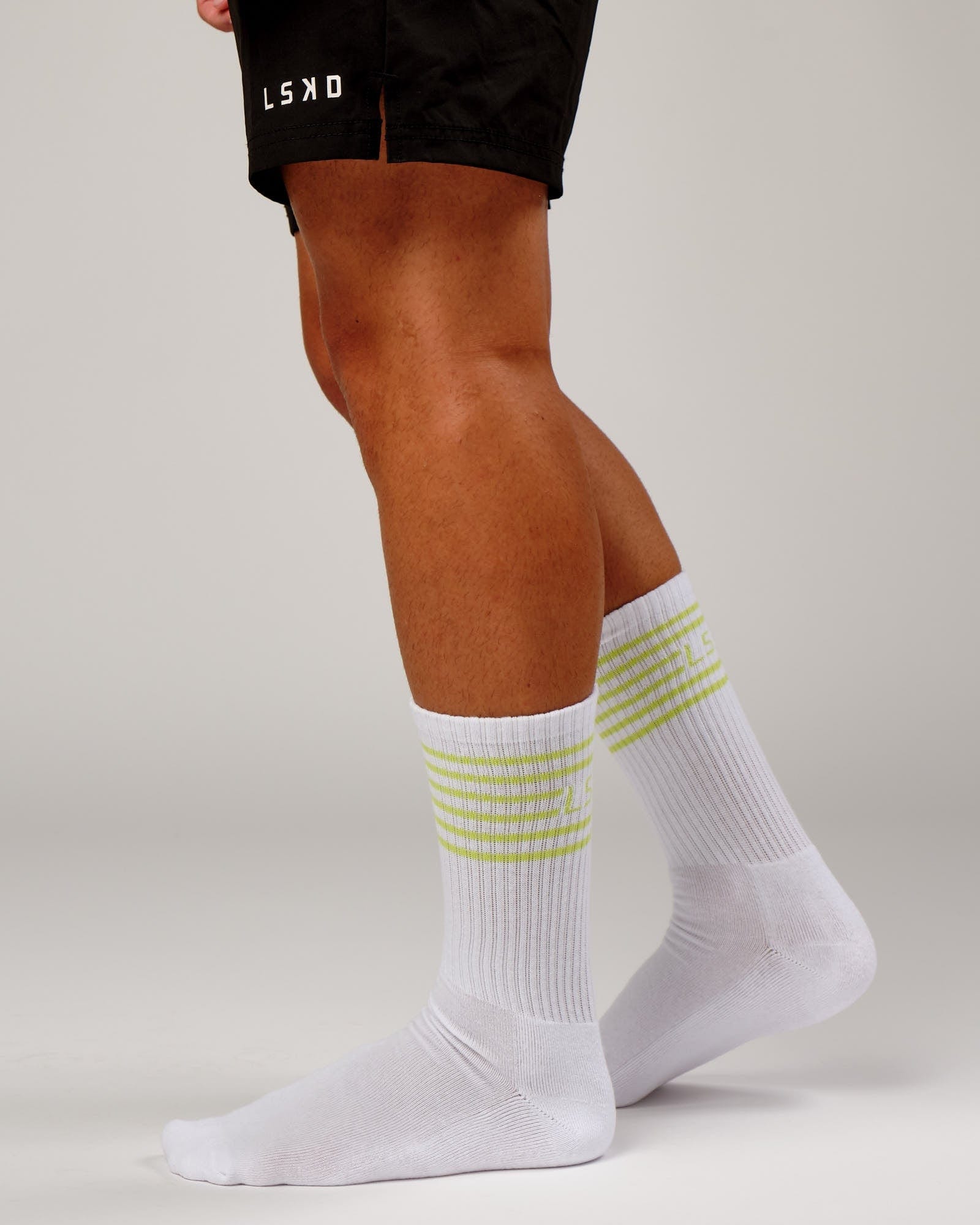 Model wearing Ignite Sock - Fluro Lime