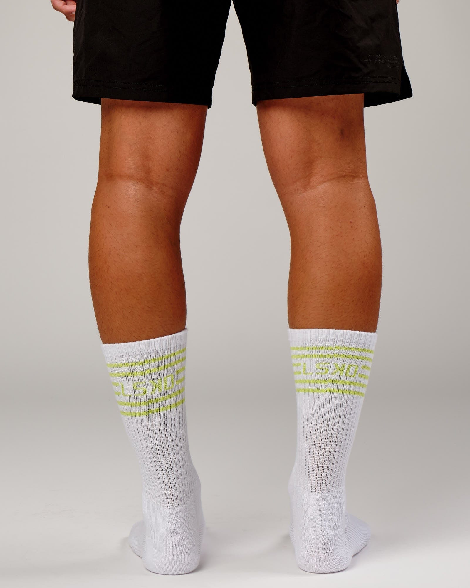Model wearing Ignite Sock - Fluro Lime