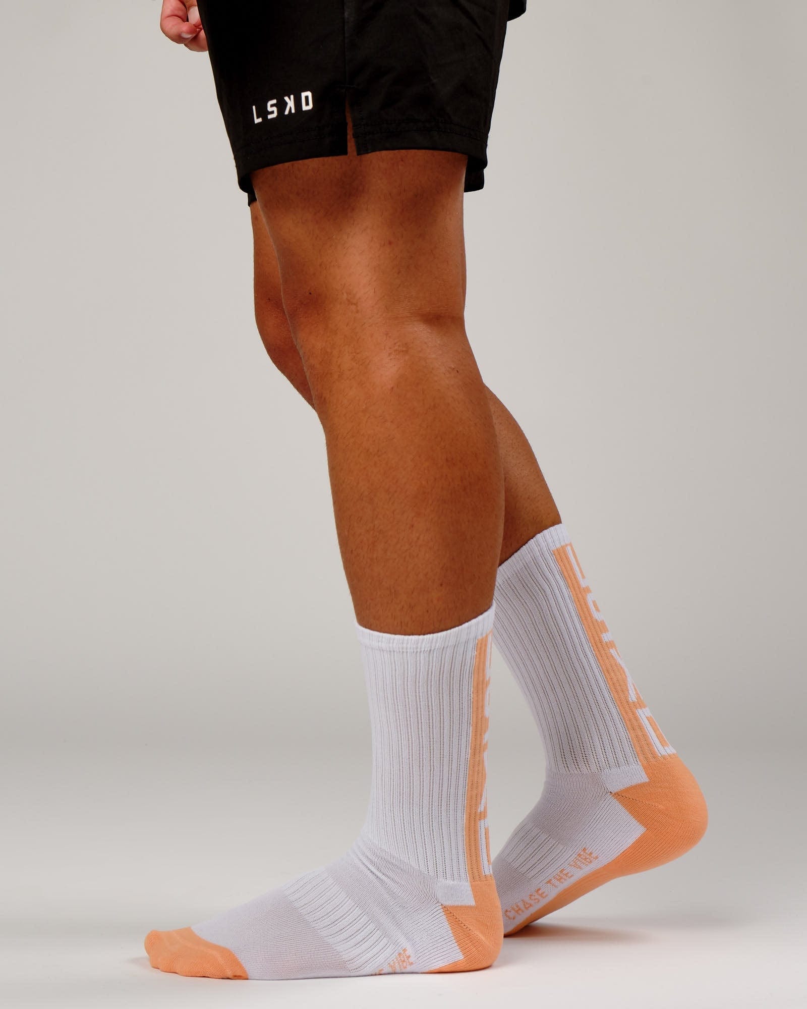 Model wearing Swish Crew Performance Sock - Sherbet