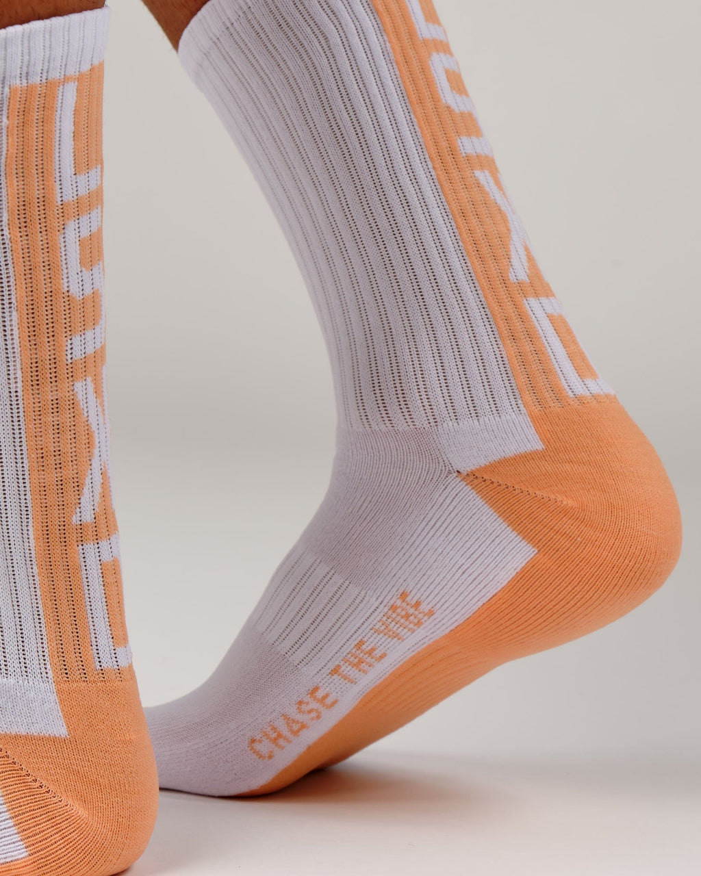 Model wearing Swish Crew Performance Sock - Sherbet