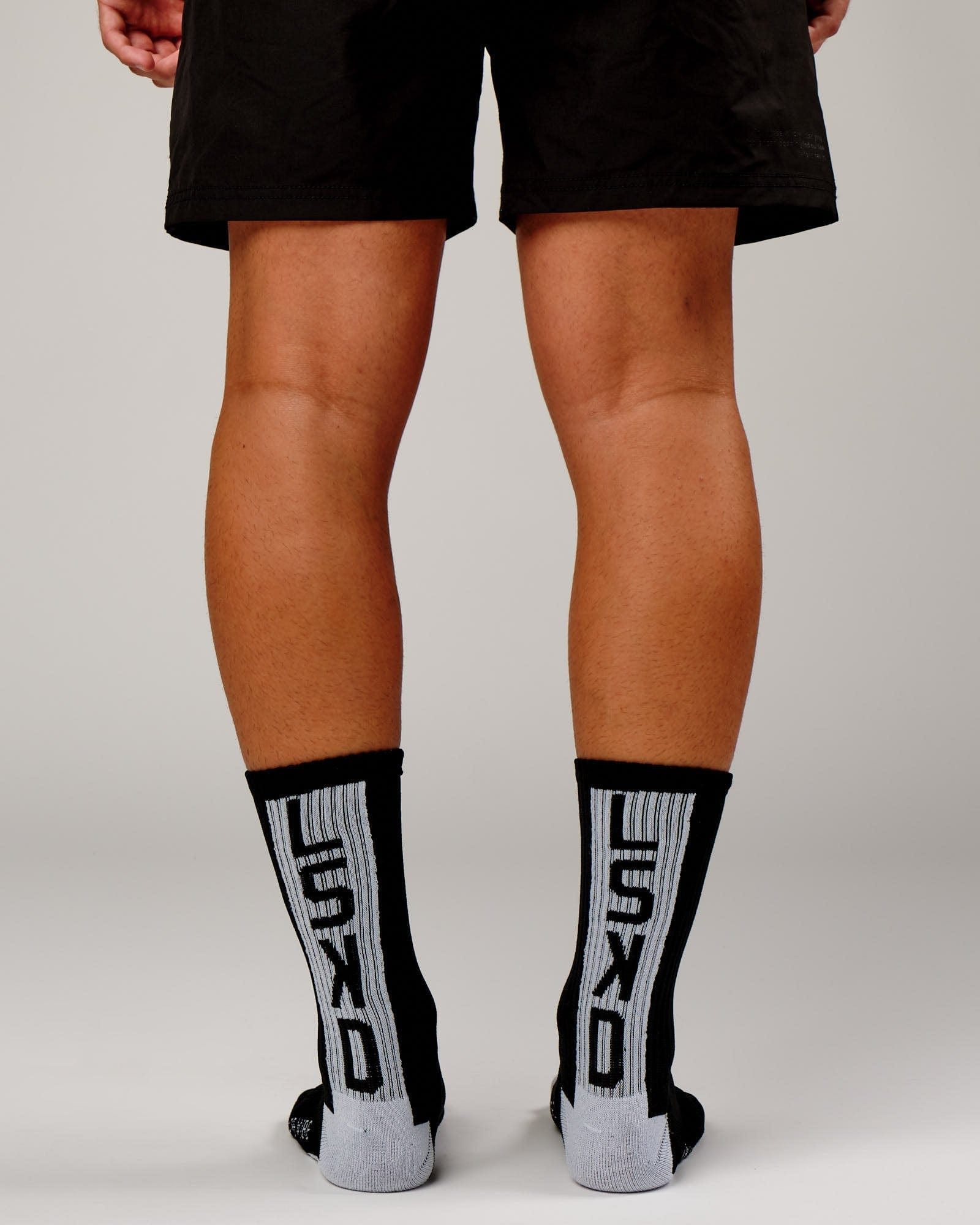 Model wearing Swish Crew Performance Sock - Black-White