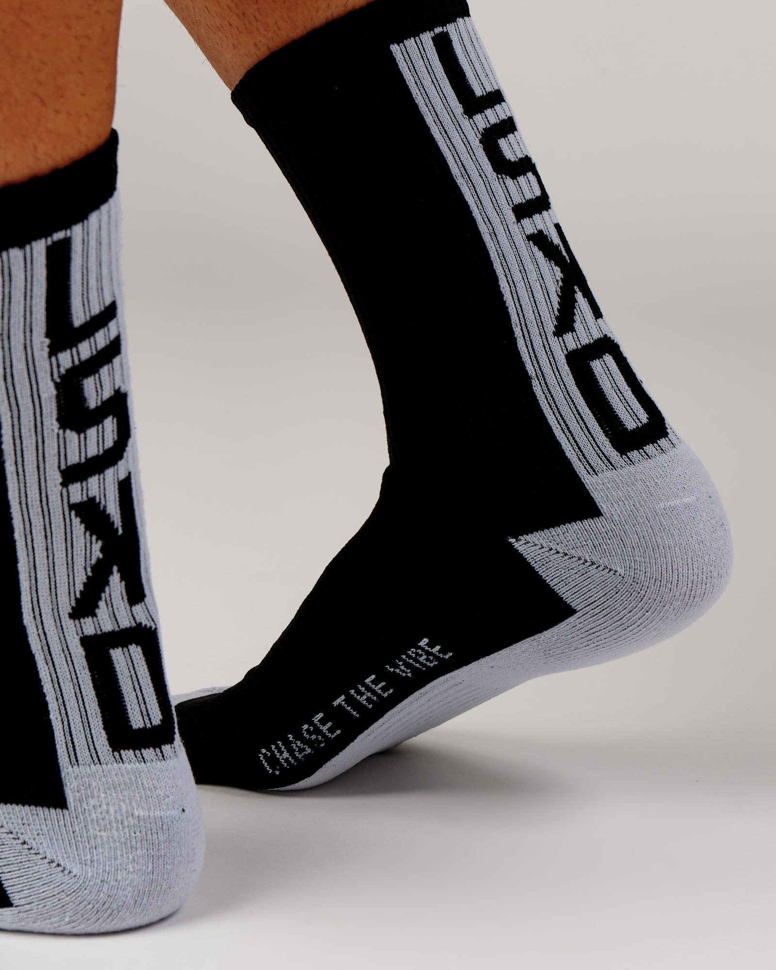 Model wearing Swish Crew Performance Sock - Black-White