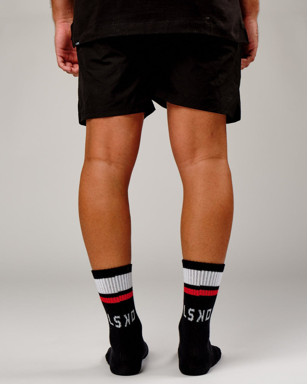 Model wearing Chiller Crew Sock - Black-Red