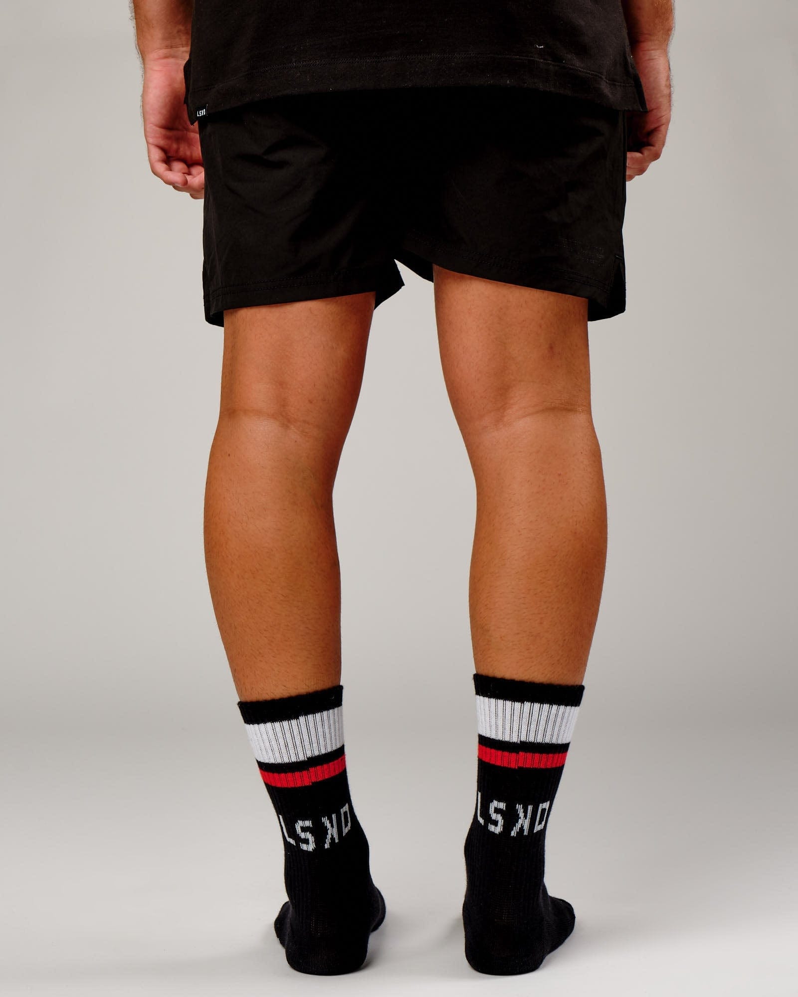 Model wearing Chiller Crew Sock - Black-Red
