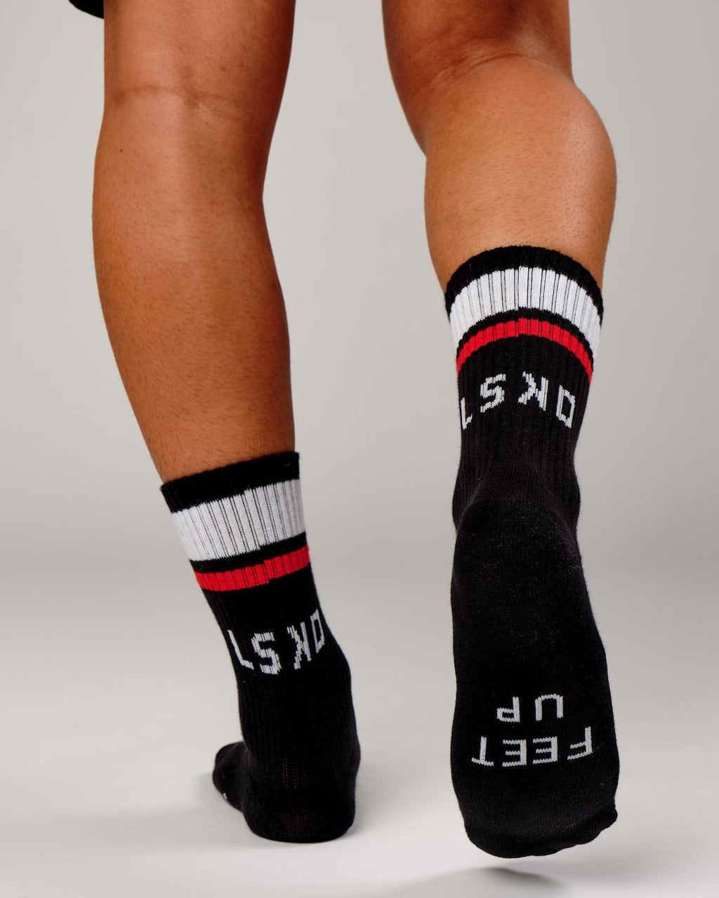 Model wearing Chiller Crew Sock - Black-Red