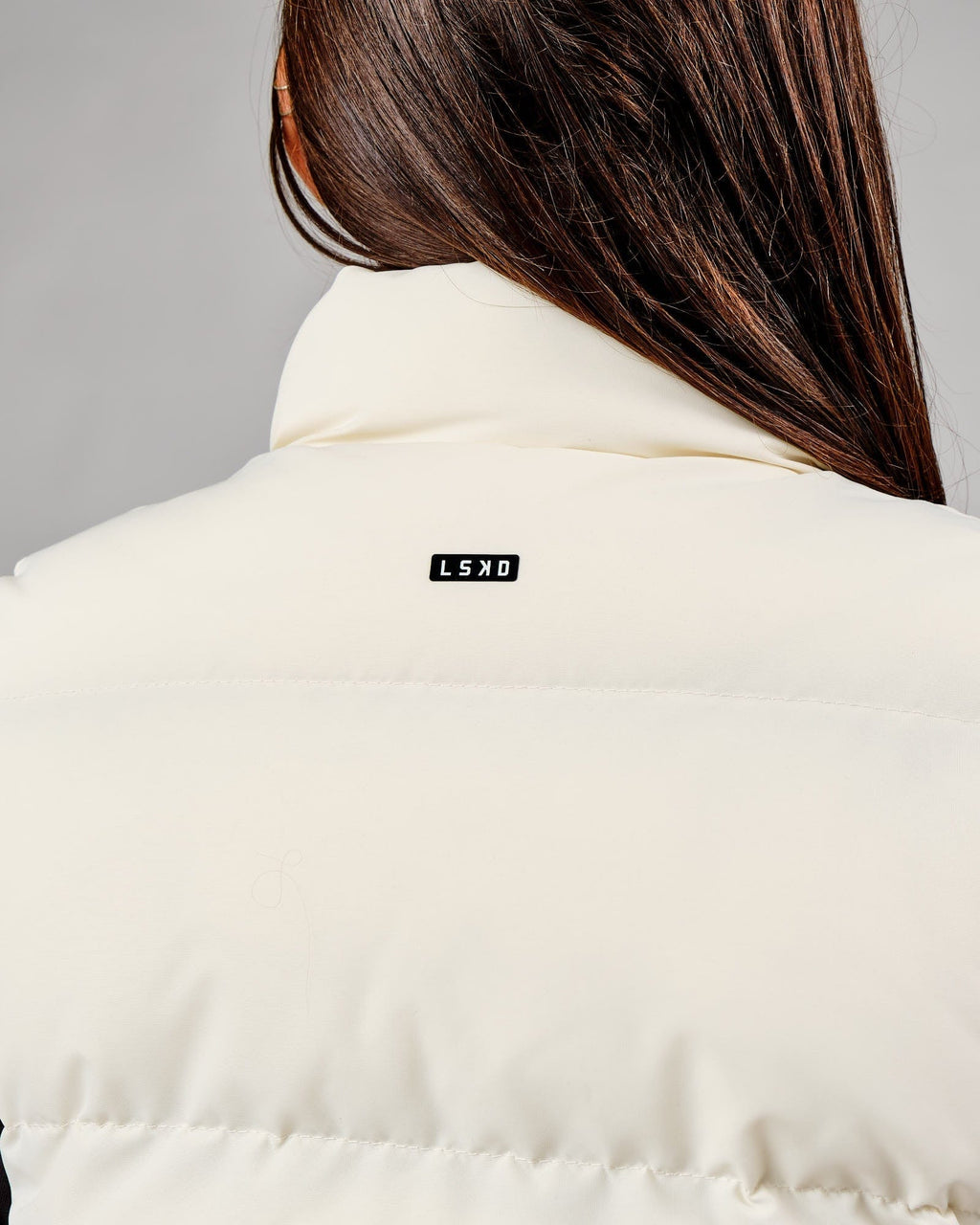 Model wearing Essential Puffer Vest - Cream