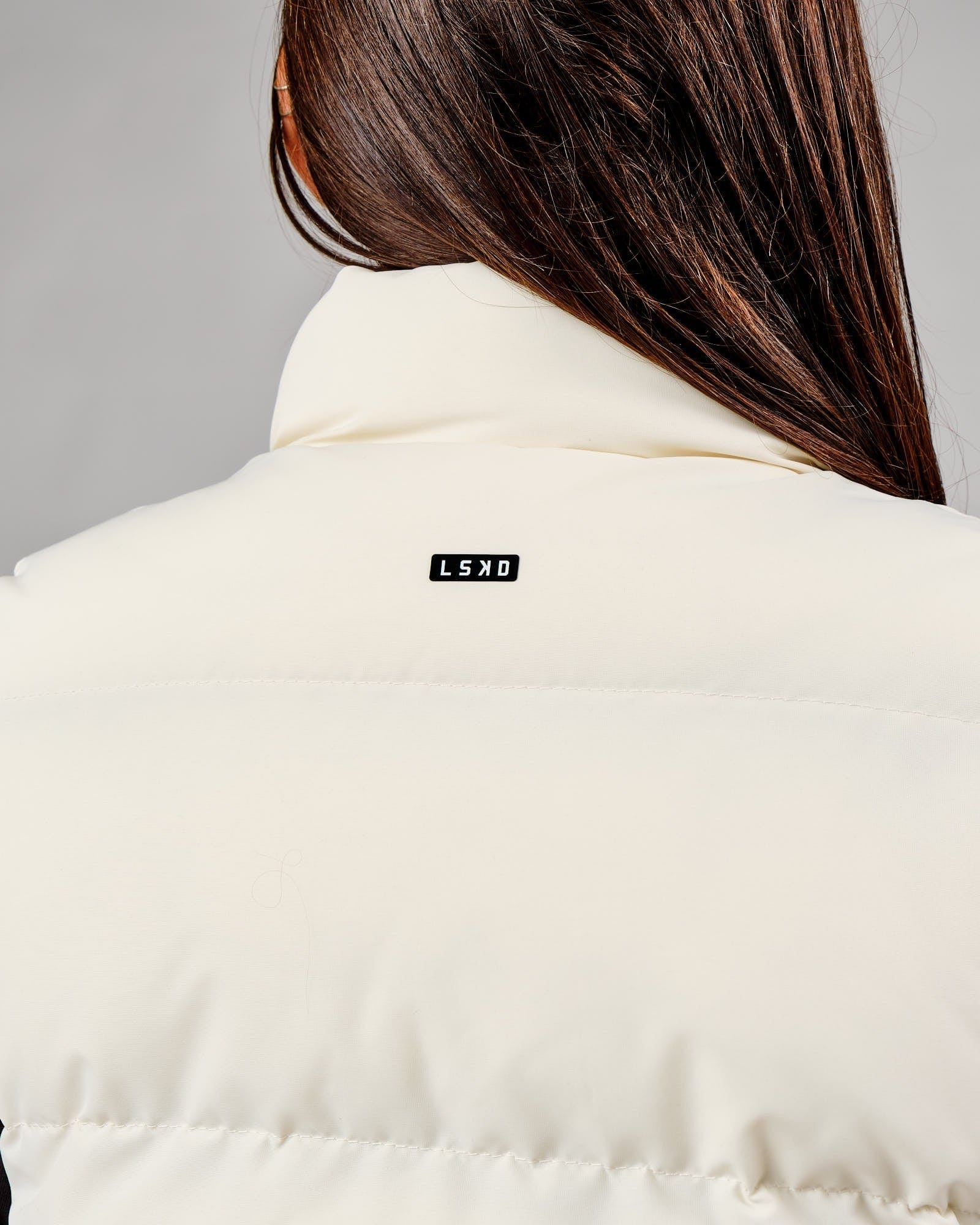 Model wearing Essential Puffer Vest - Cream