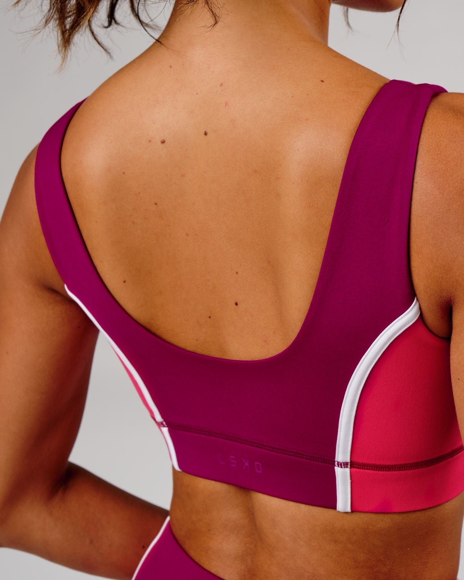 Model wearing Hunter Sports Bra - Candy Apple-Boysenberry