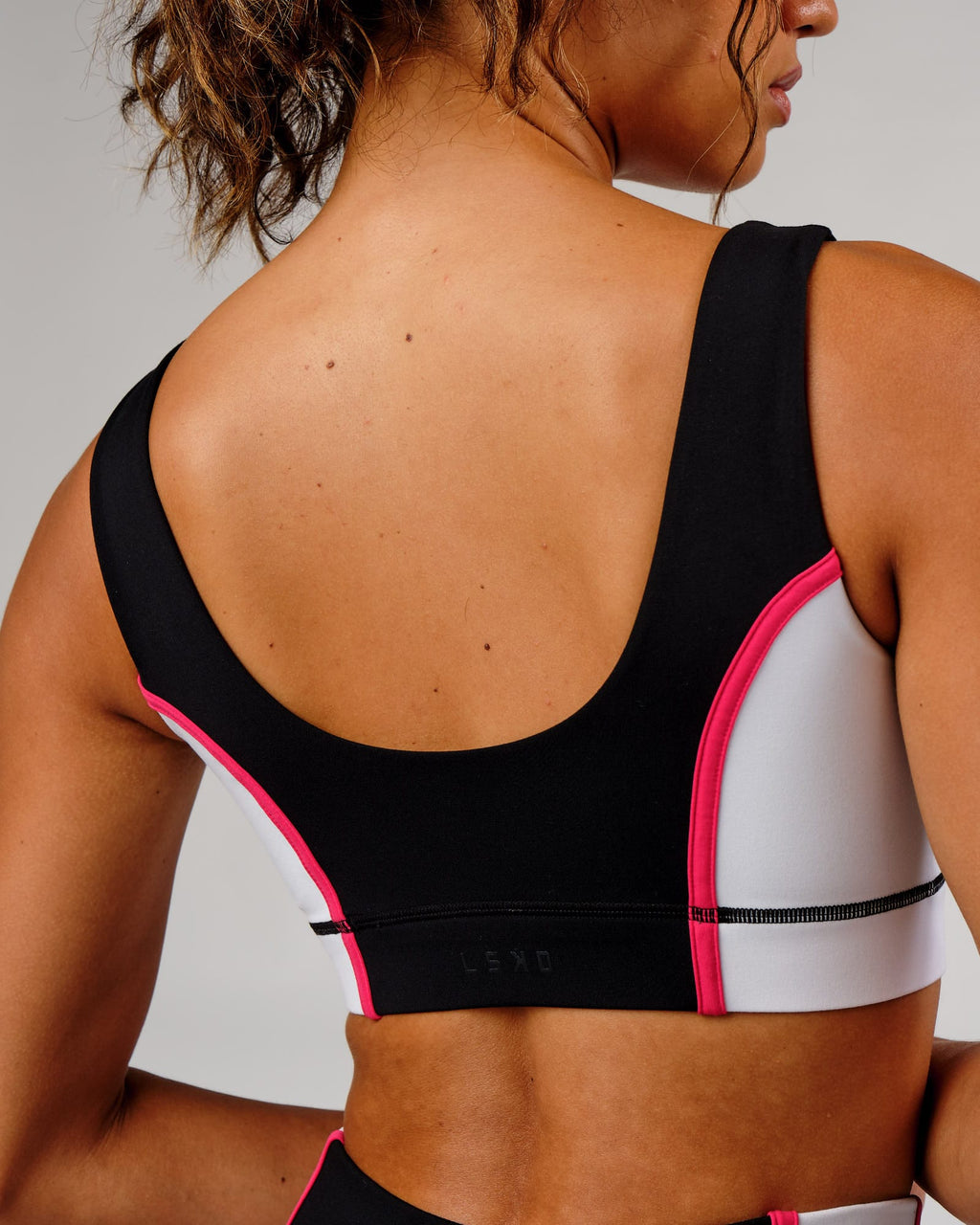 Model wearing Hunter Sports Bra - Black-White-Boysenberry