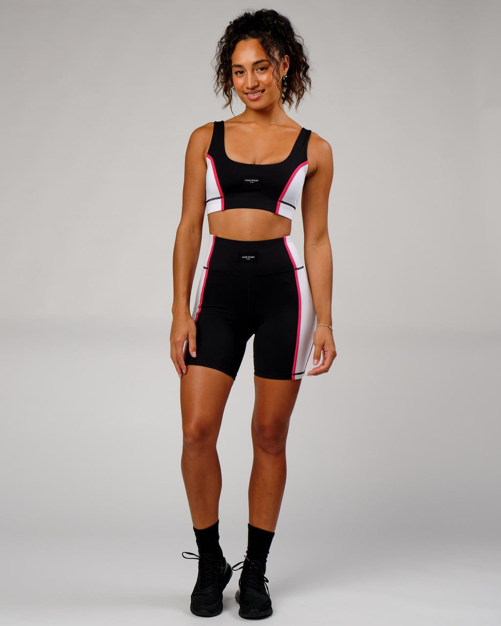 Model wearing Hunter Sports Bra - Black-White-Boysenberry