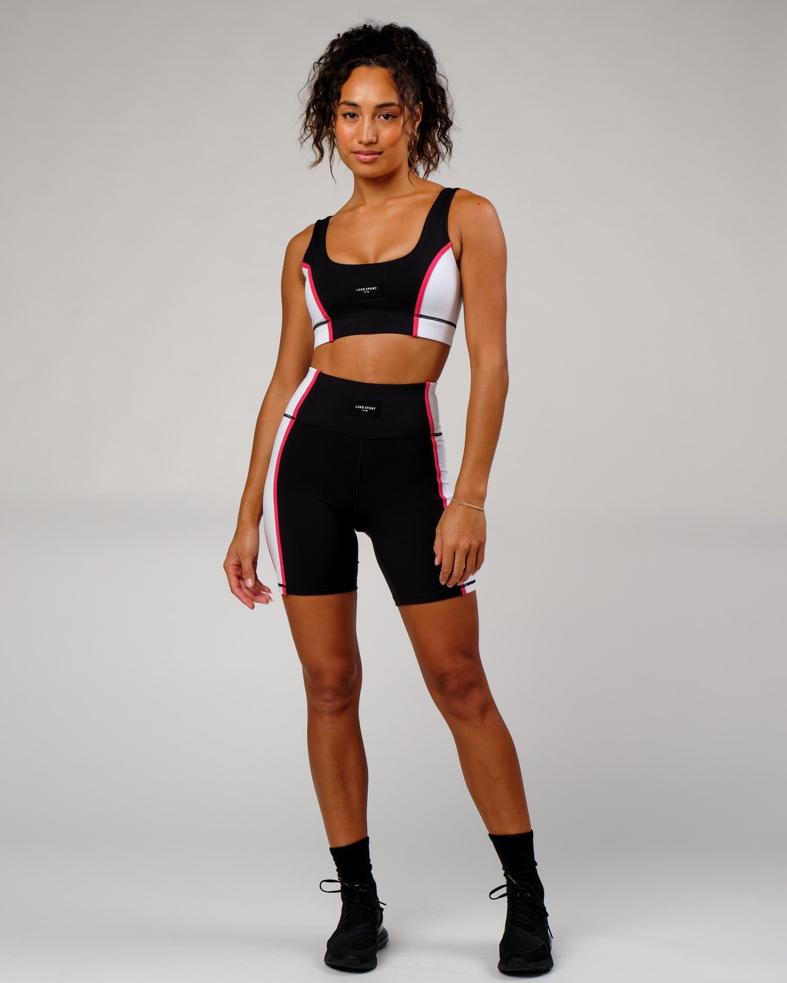 Model wearing Hunter Mid Short Tight - Black-White-Boysenberry