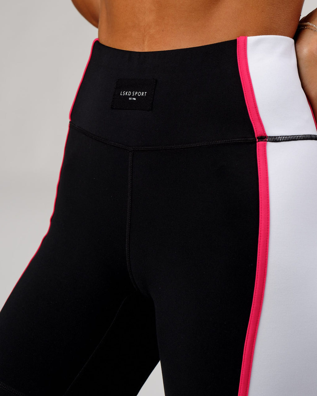 Model wearing Hunter Mid Short Tight - Black-White-Boysenberry