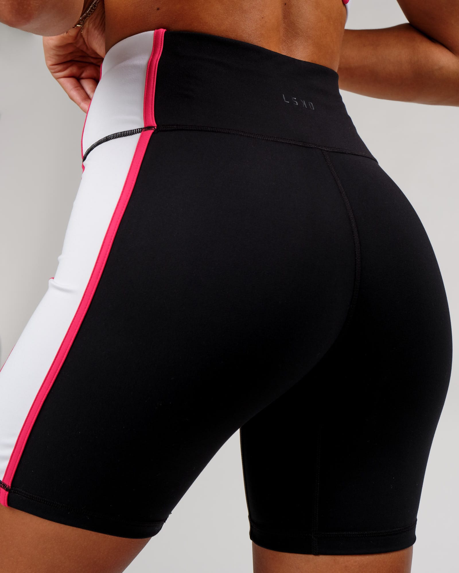 Model wearing Hunter Mid Short Tight - Black-White-Boysenberry