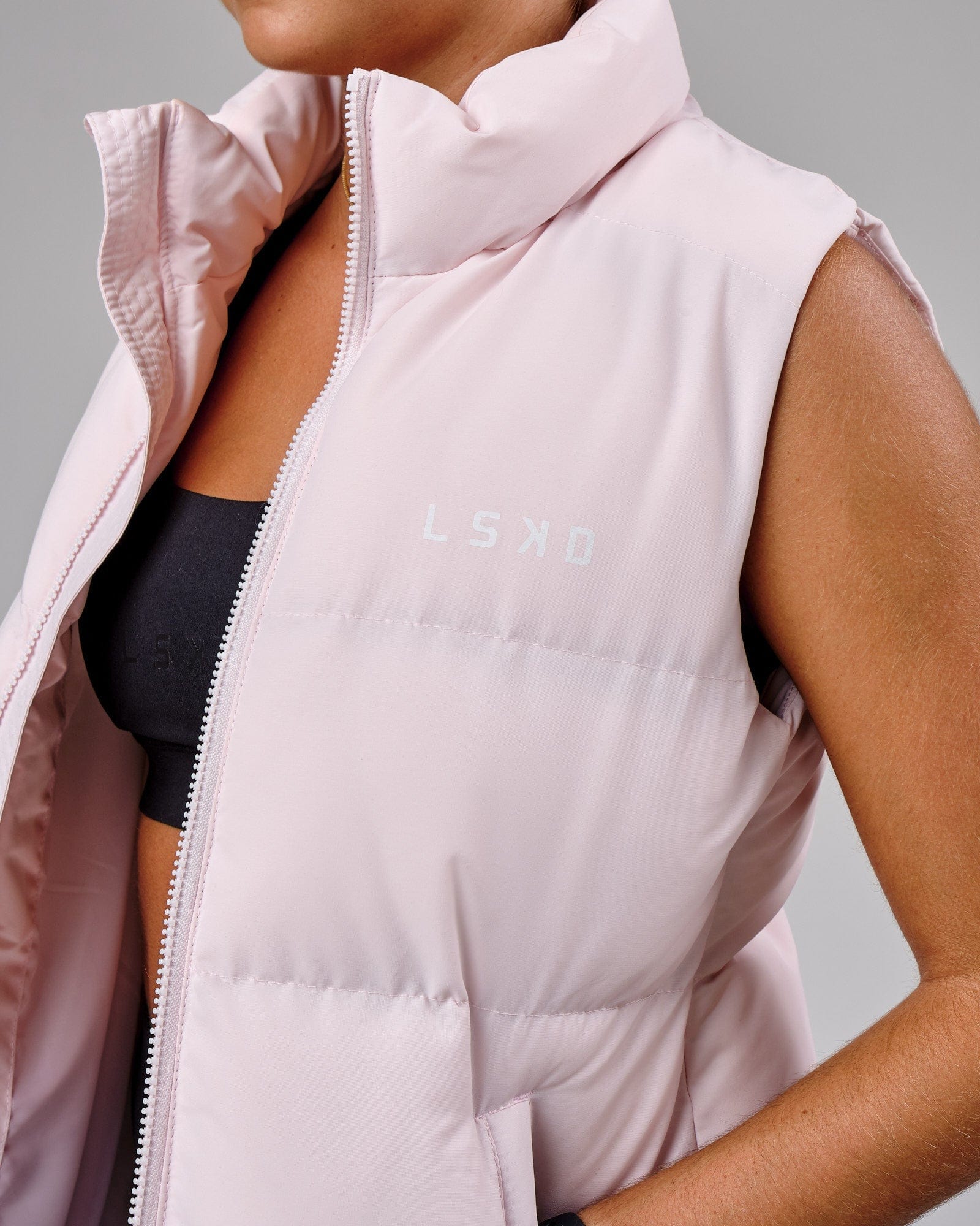 Model wearing Essential Puffer Vest - Orchid ice
