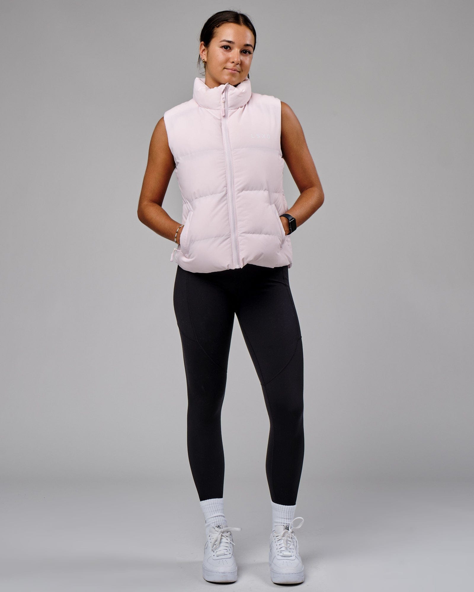 Model wearing Essential Puffer Vest - Orchid ice