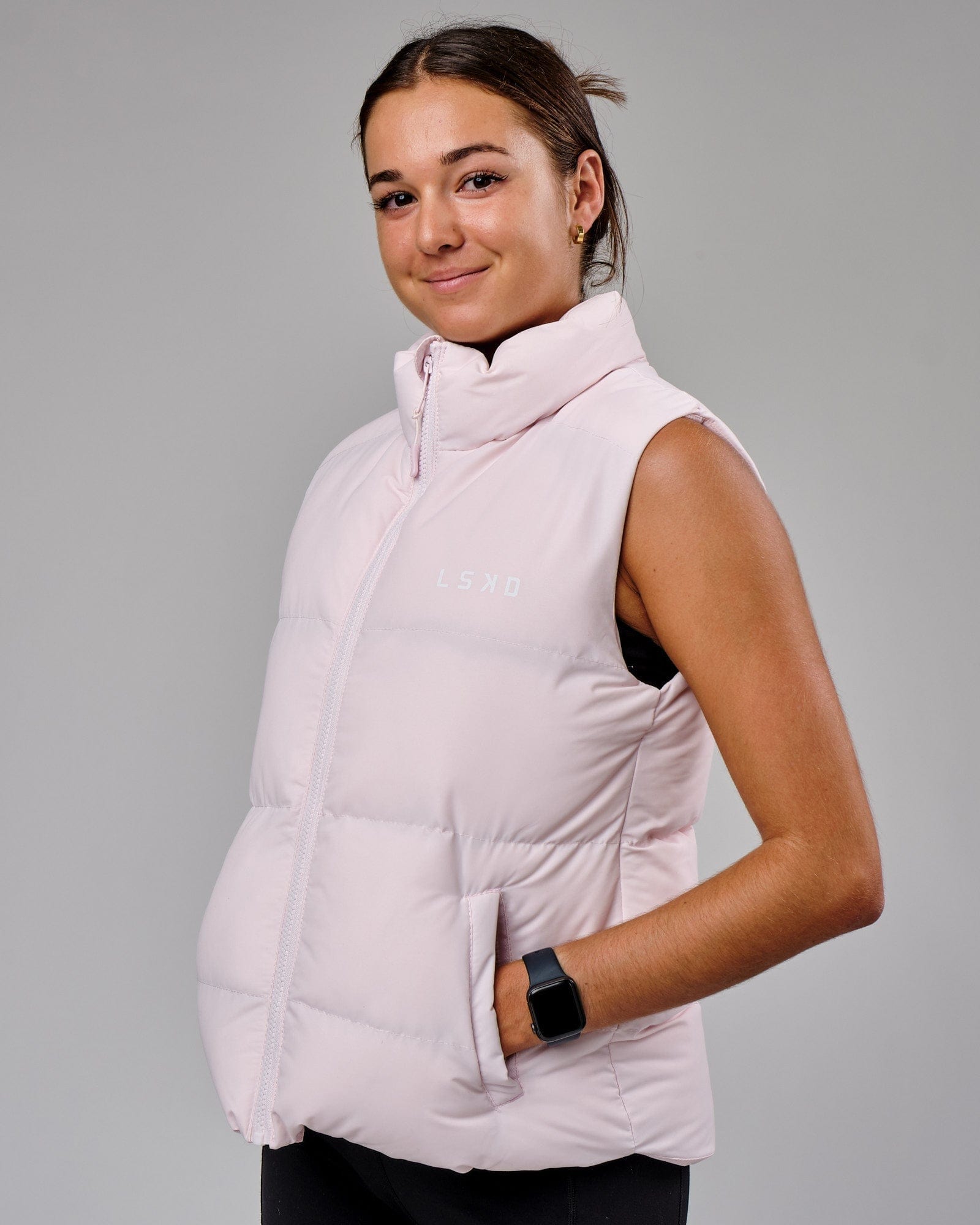 Model wearing Essential Puffer Vest - Orchid ice
