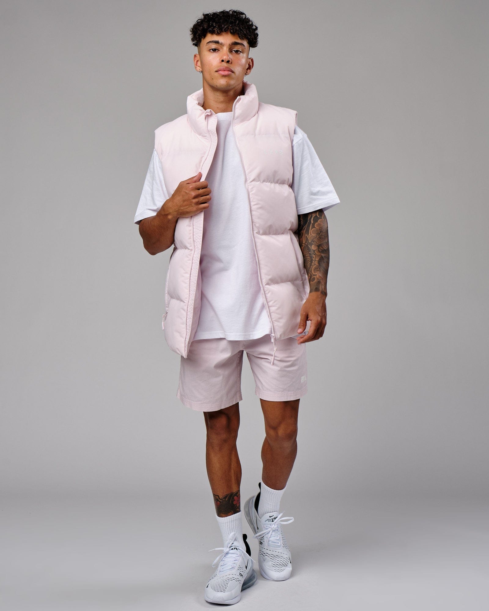 Model wearing Essential Puffer Vest - Orchid ice