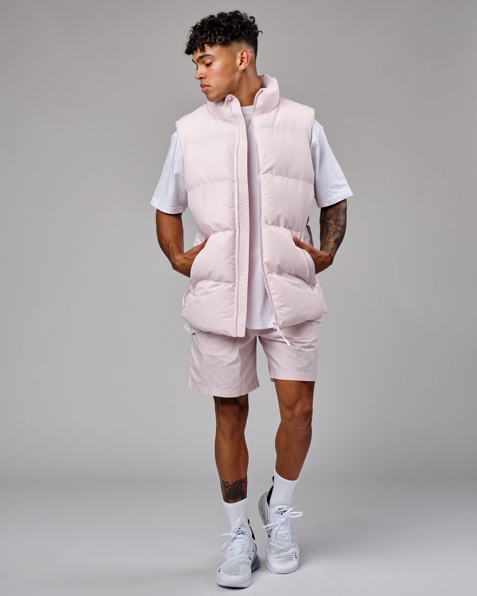 Model wearing Essential Puffer Vest - Orchid ice