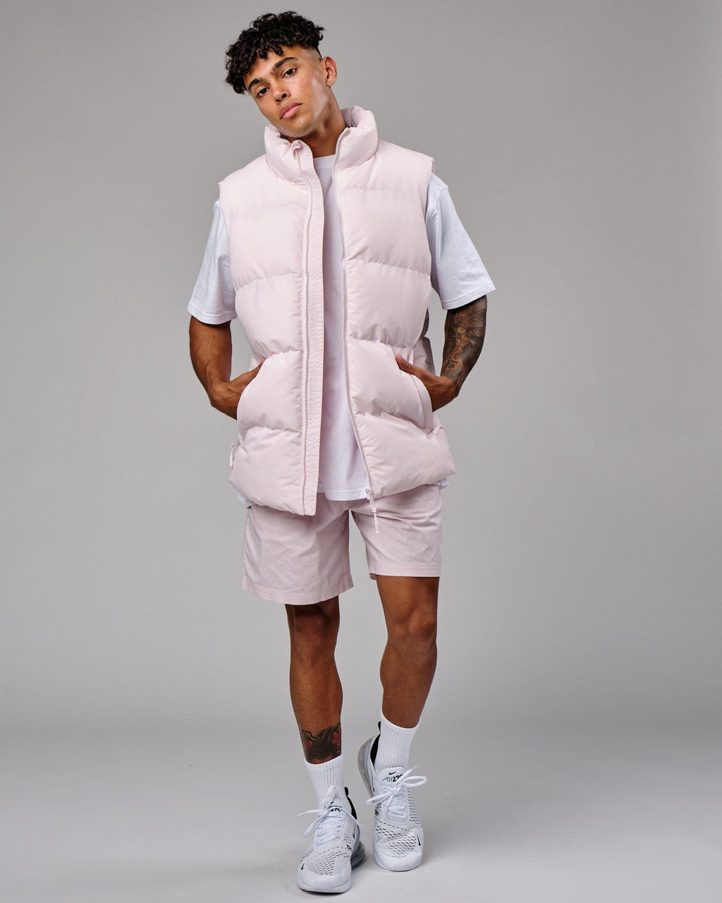 Model wearing Essential Puffer Vest - Orchid ice