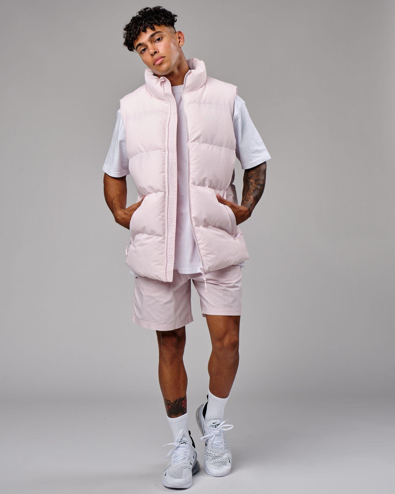 Model wearing Essential Puffer Vest - Orchid ice