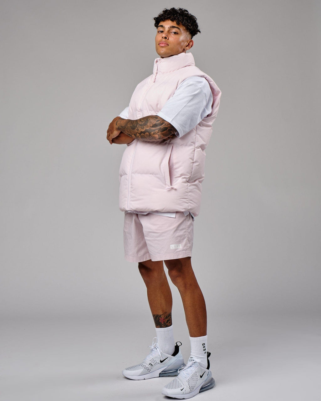 Model wearing Essential Puffer Vest - Orchid ice