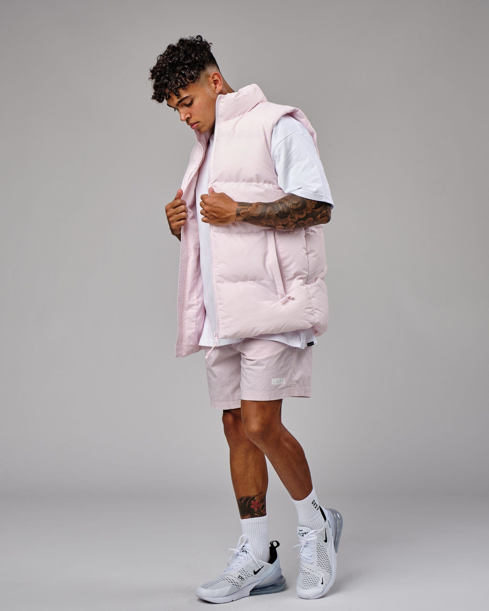 Model wearing Essential Puffer Vest - Orchid ice