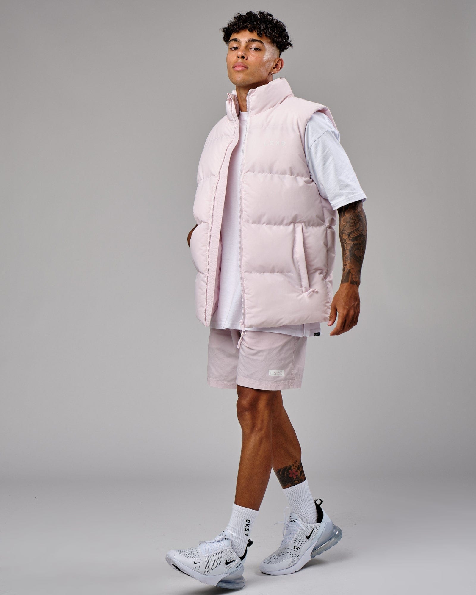 Model wearing Essential Puffer Vest - Orchid ice