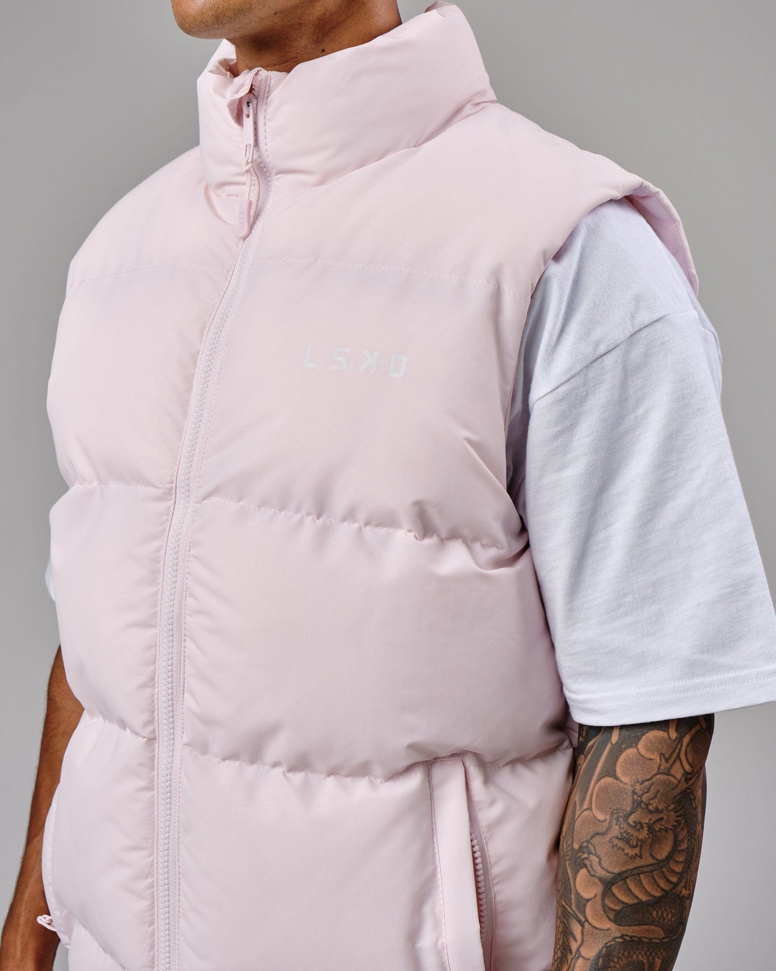 Model wearing Essential Puffer Vest - Orchid ice