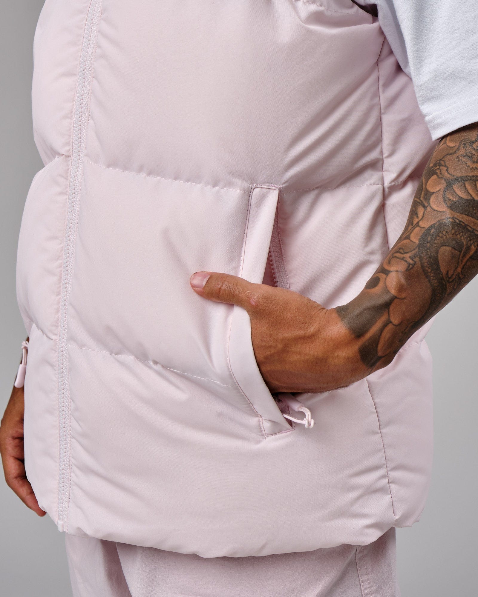 Model wearing Essential Puffer Vest - Orchid ice