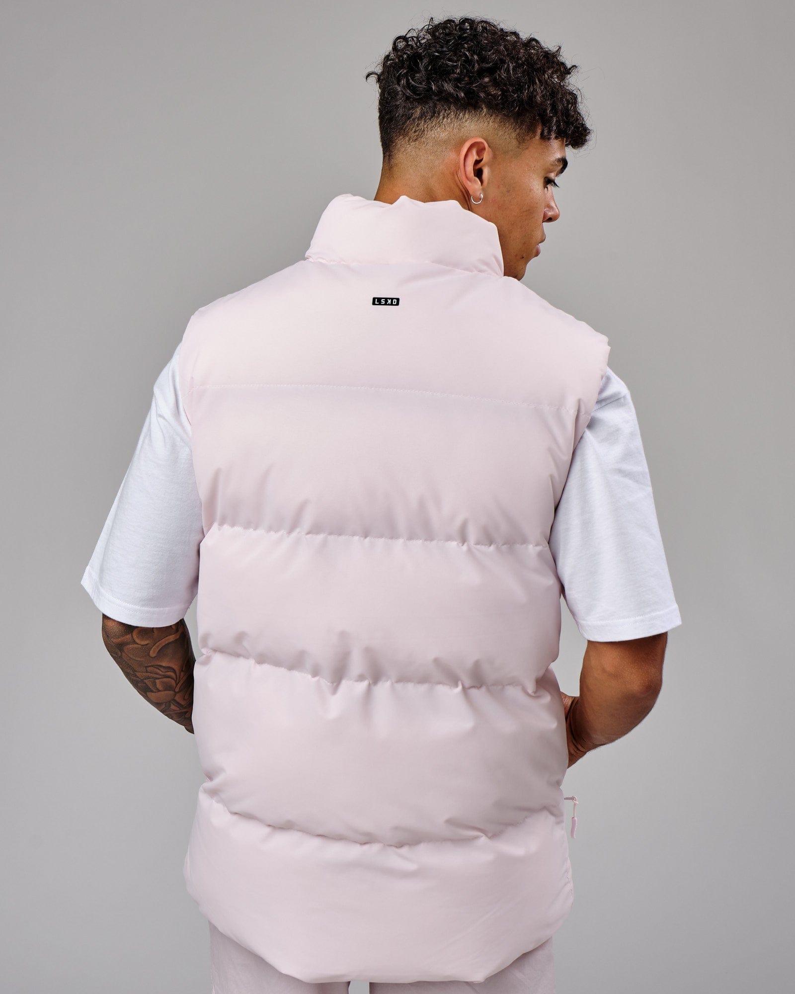 Model wearing Essential Puffer Vest - Orchid ice