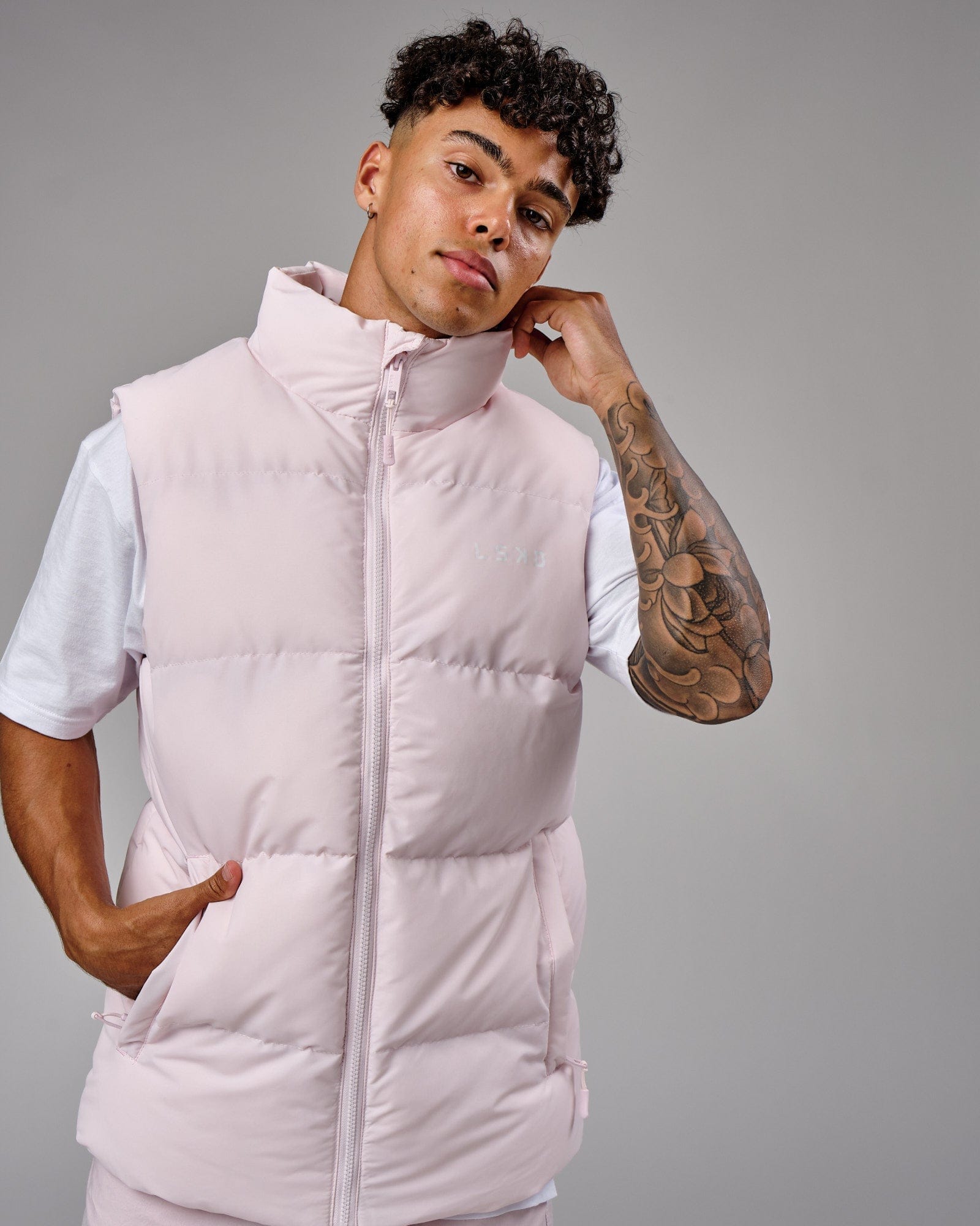 Model wearing Essential Puffer Vest - Orchid ice