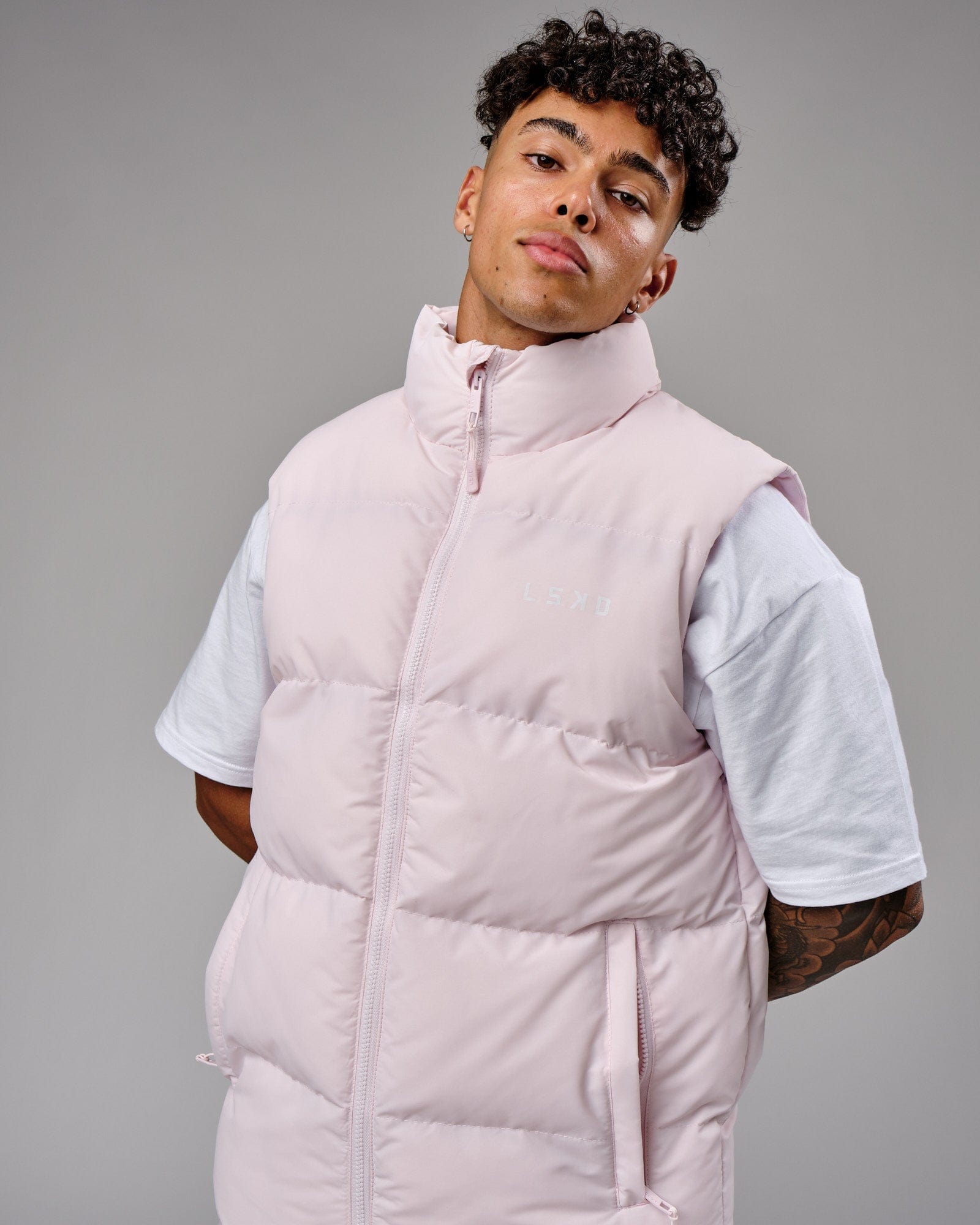 Model wearing Essential Puffer Vest - Orchid ice
