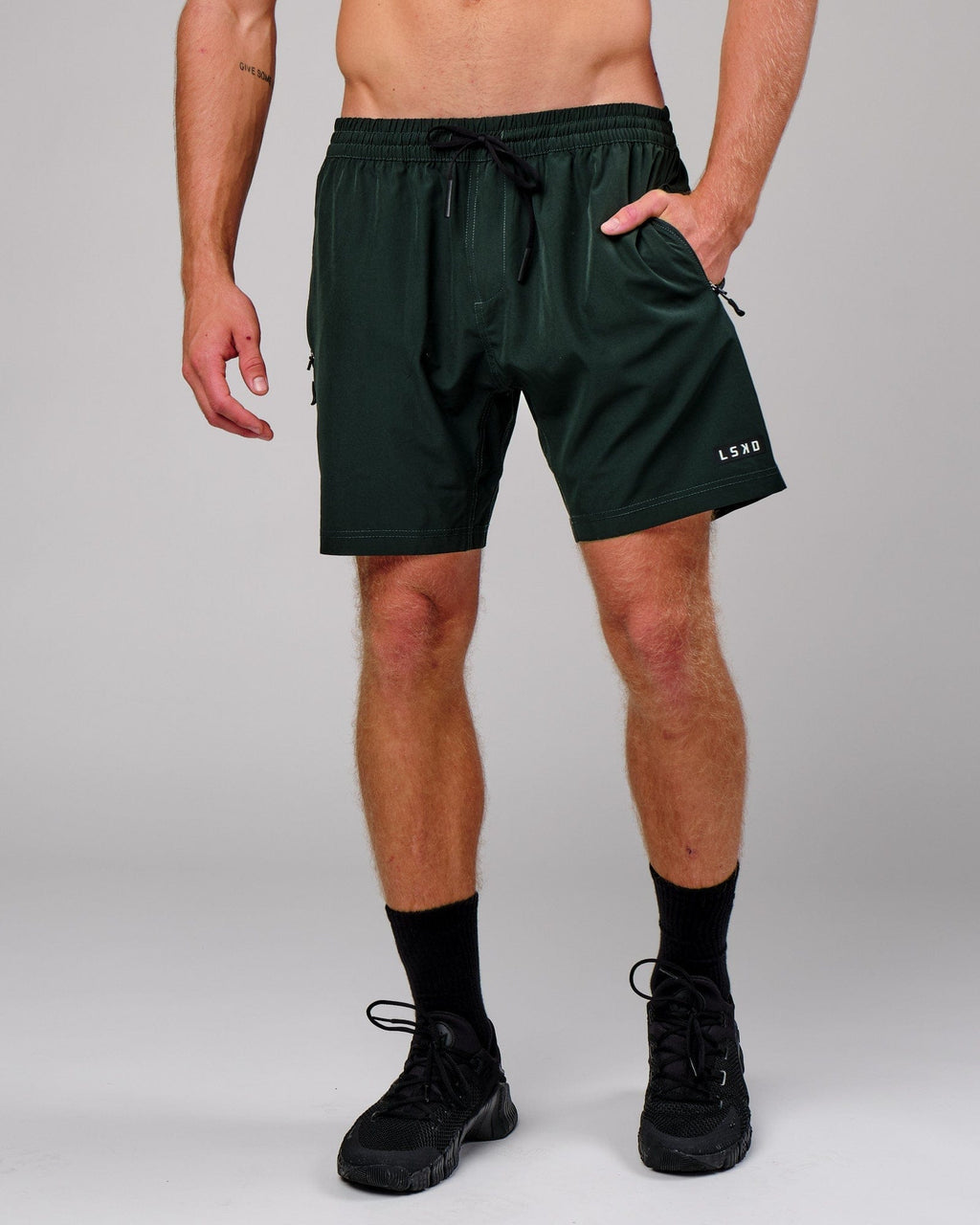 Model wearing Rep 7" Performance Short - Forest