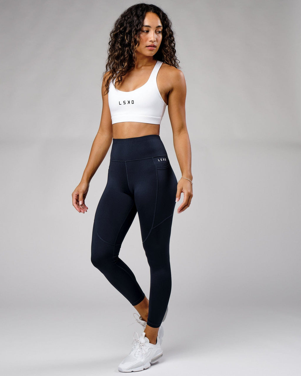 Model wearing Rep Full Length Tight Small Logo - Navy