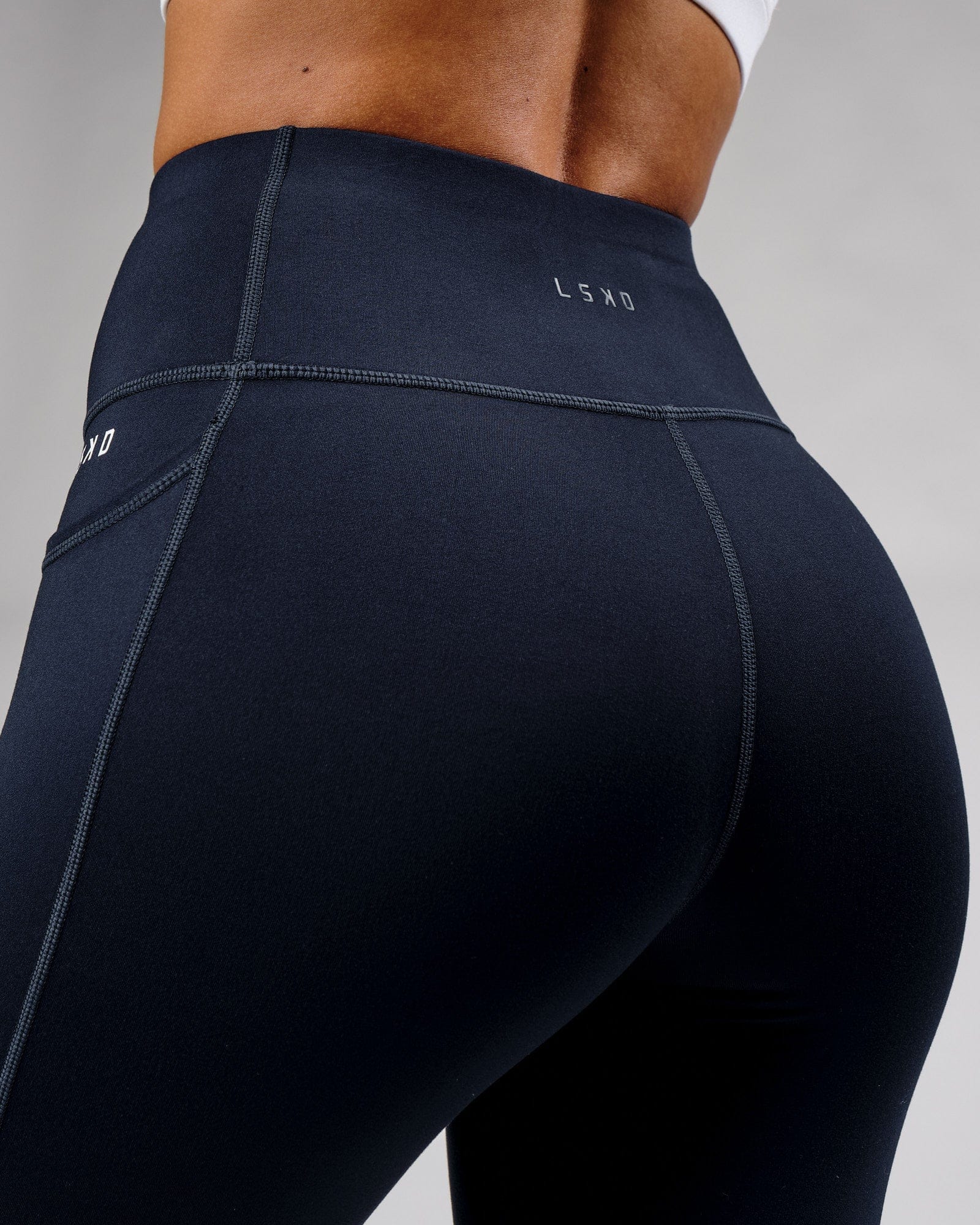 Model wearing Rep Full Length Tight Small Logo - Navy