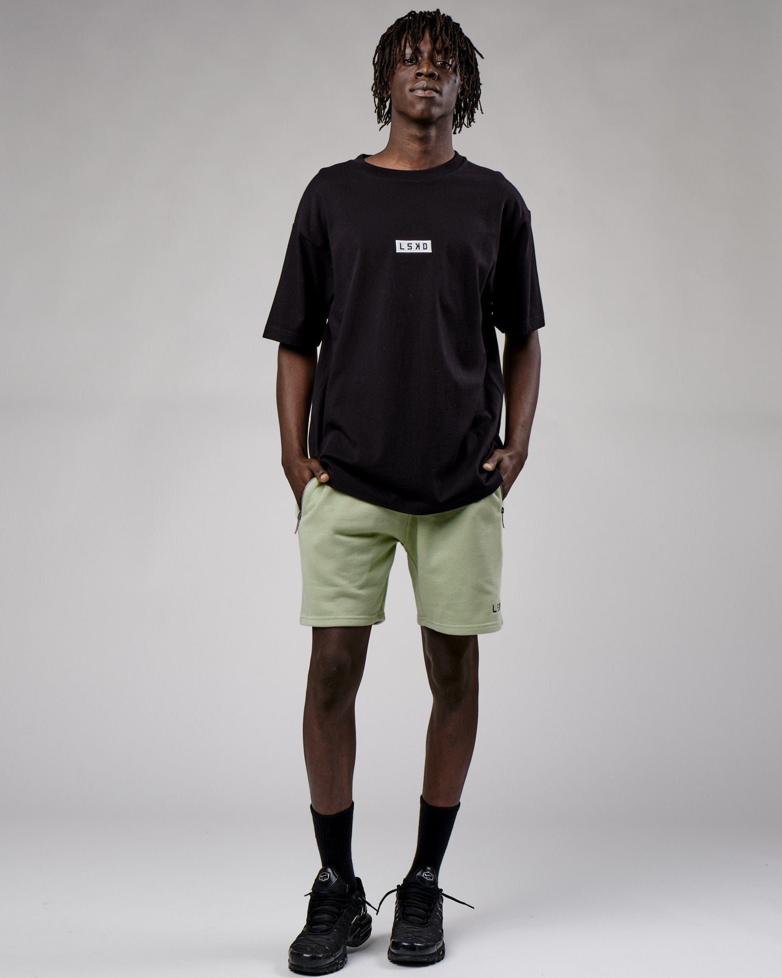 Model wearing Cornerstone Tee Oversize - Black