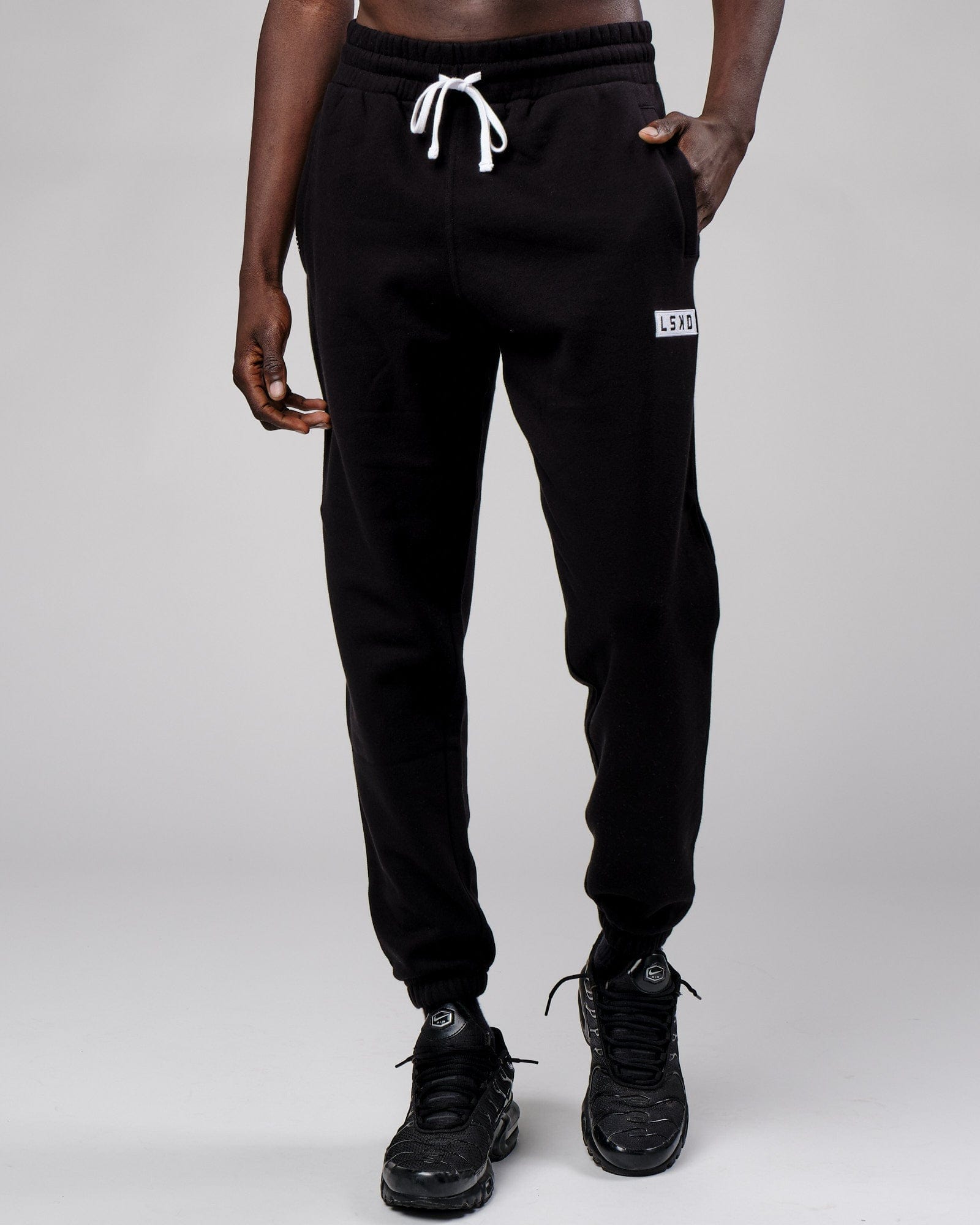 Model wearing Cornerstone Track Pant Oversize - Black
