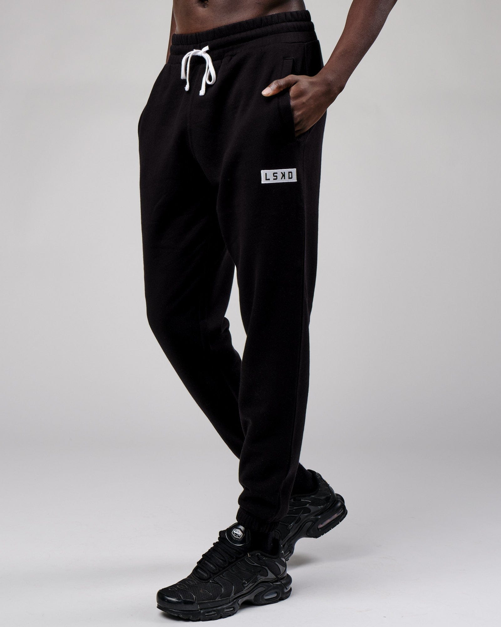 Model wearing Cornerstone Track Pant Oversize - Black