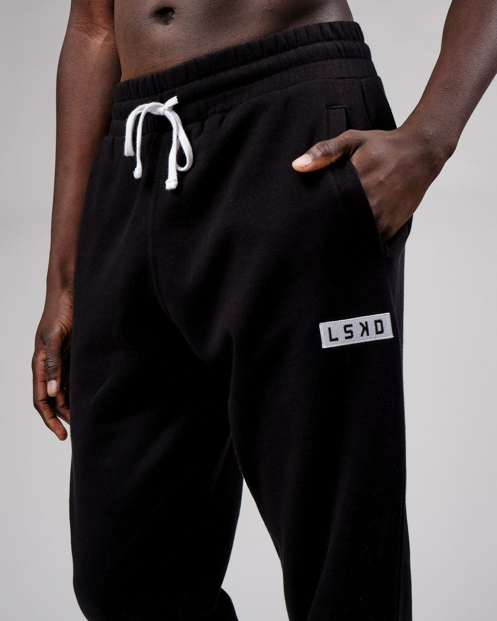 Model wearing Cornerstone Track Pant Oversize - Black