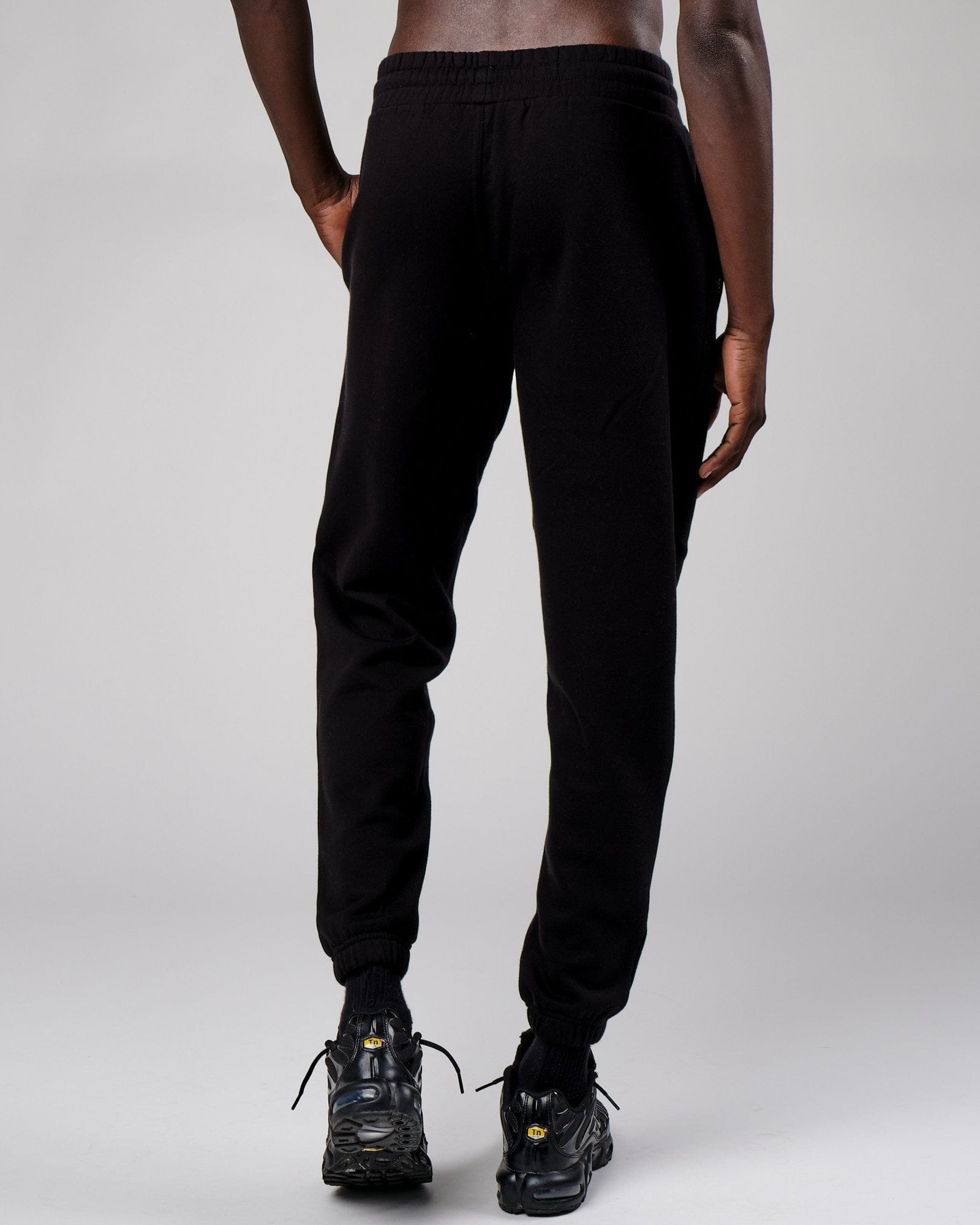 Model wearing Cornerstone Track Pant Oversize - Black