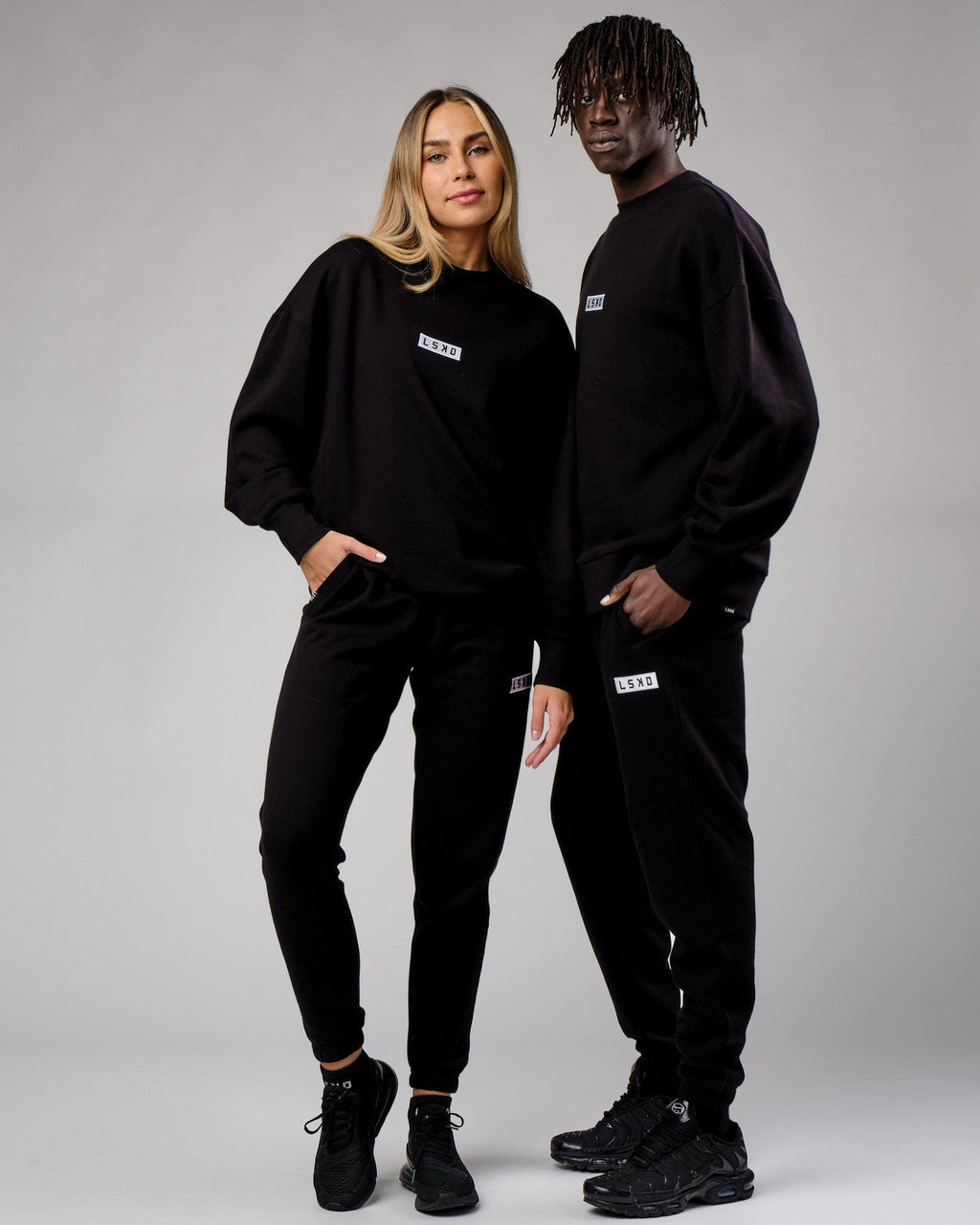 Model wearing Unisex Cornerstone Track Pant Oversize - Black